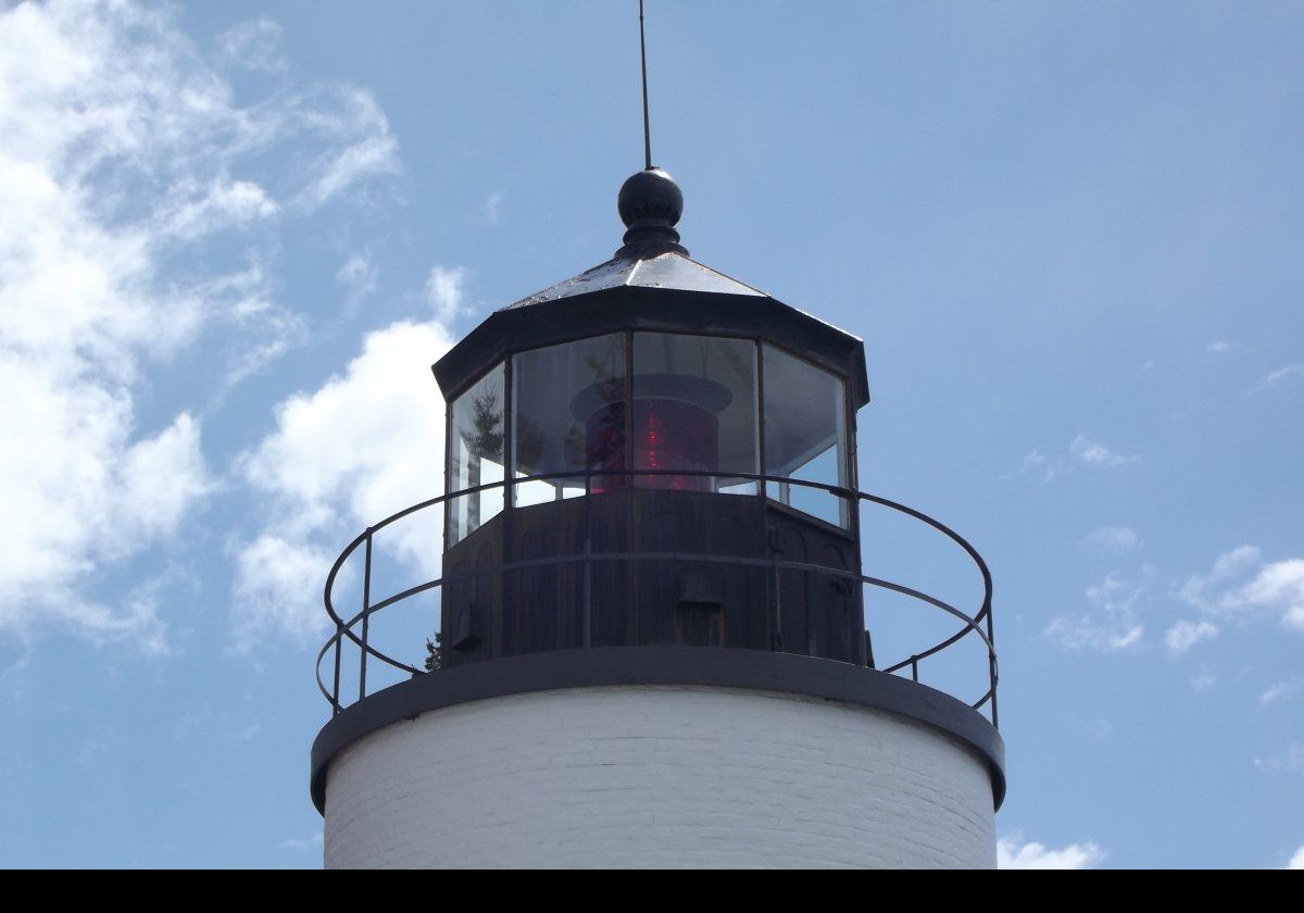 The lighthouse was automated in 1976, and remains in use as accommodation for a coast-guard family. There is a public path to the bell and lighthouse, see the image on the right, although the buildings and most of the grounds are private. It remains in active service, and shows a red light from the fourth-order Fresnel lens that was installed in 1902, replacing the earlier fifth-order lens.