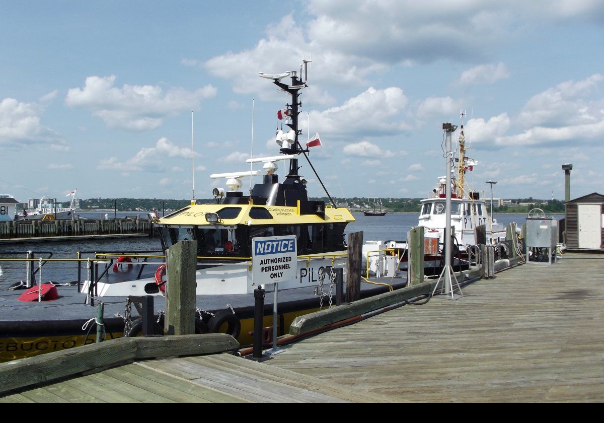 Two of the harbor pilots moored on a jetty.